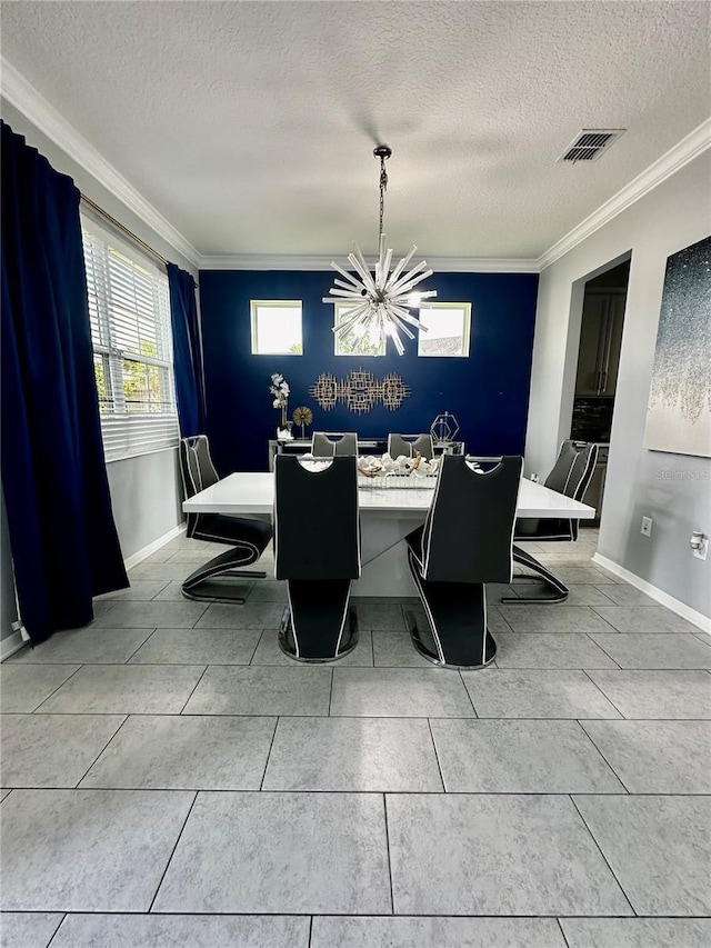 tiled dining room featuring crown molding, a chandelier, and a textured ceiling