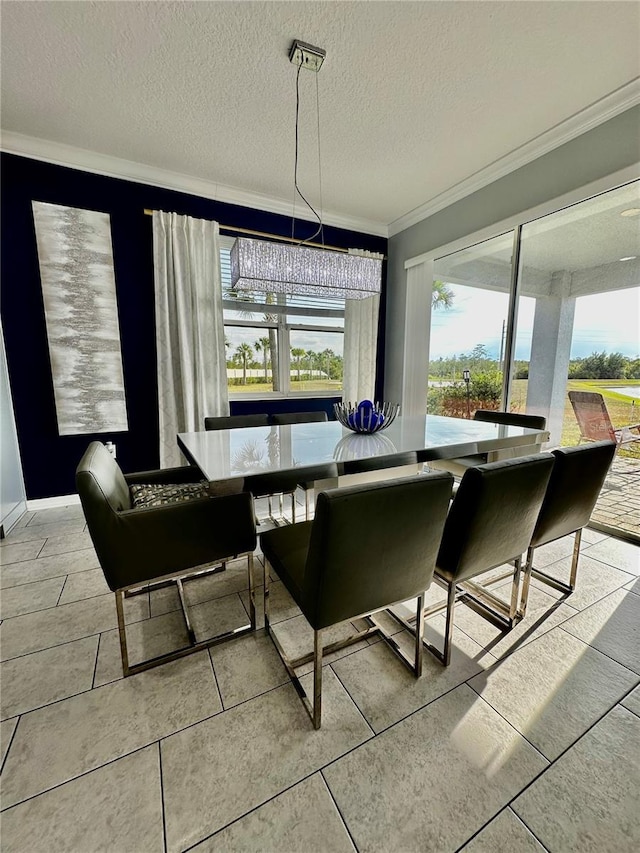 dining room featuring ornamental molding and a textured ceiling