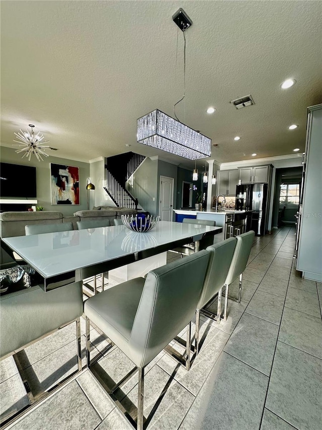 interior space featuring decorative light fixtures, gray cabinets, a textured ceiling, and black fridge