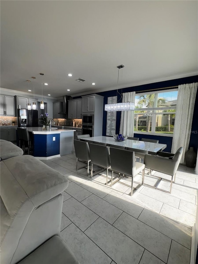 living room with light tile patterned flooring and ornamental molding