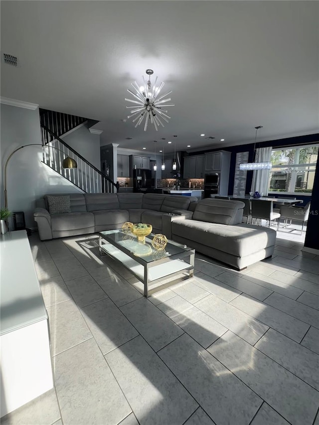 living room with crown molding and a chandelier