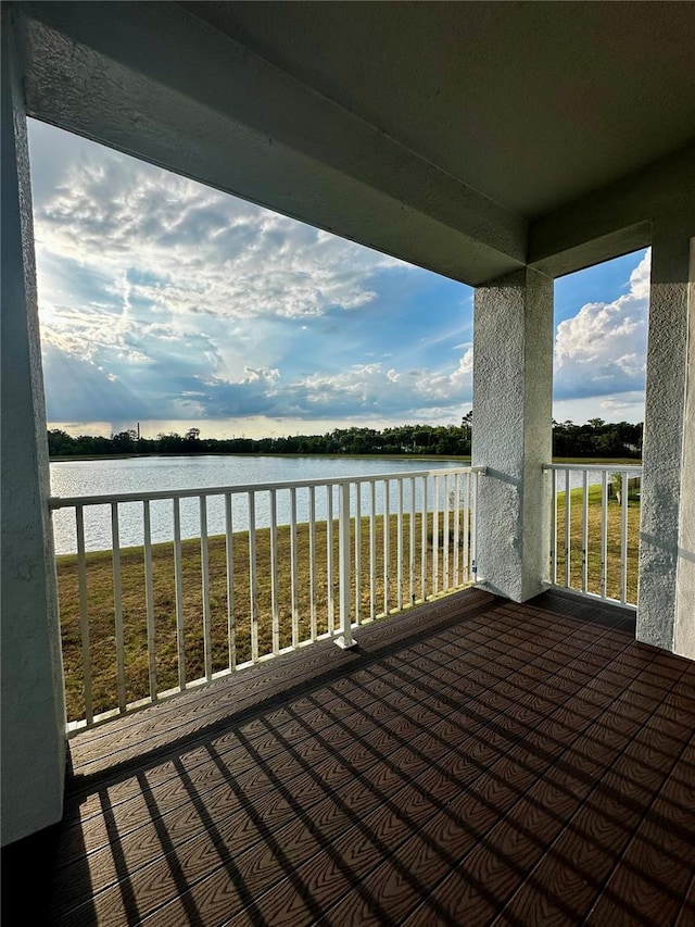 wooden terrace featuring a water view