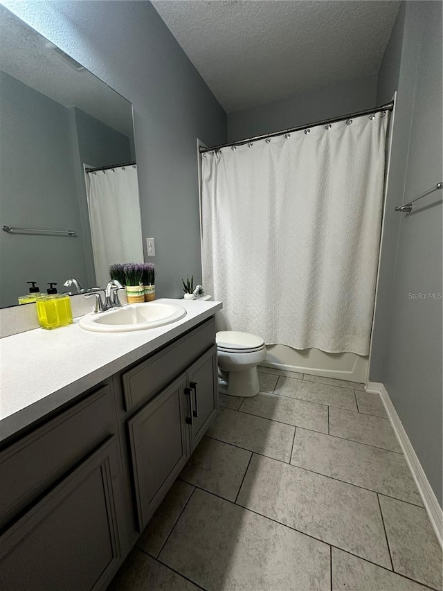 full bathroom with vanity, shower / tub combo, toilet, tile patterned floors, and a textured ceiling