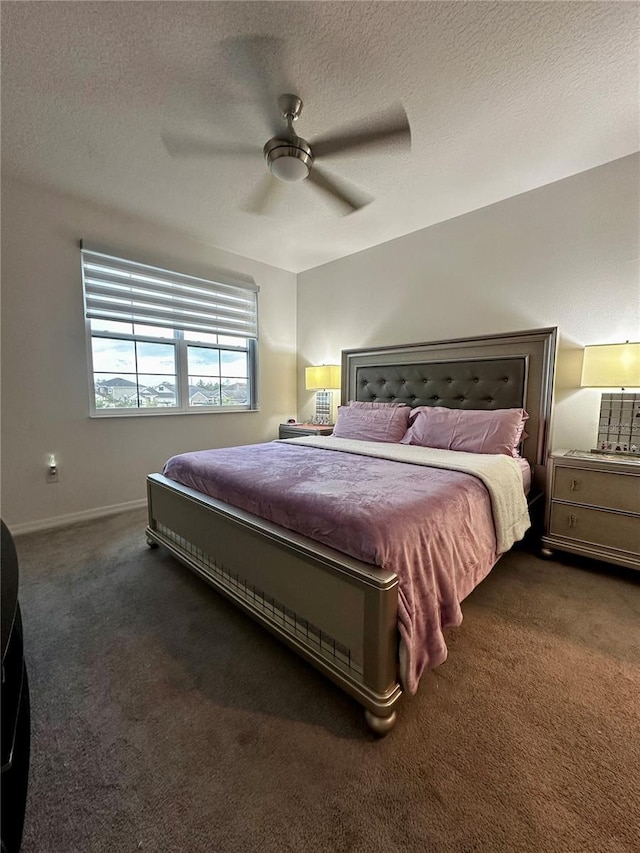 carpeted bedroom featuring a textured ceiling and ceiling fan