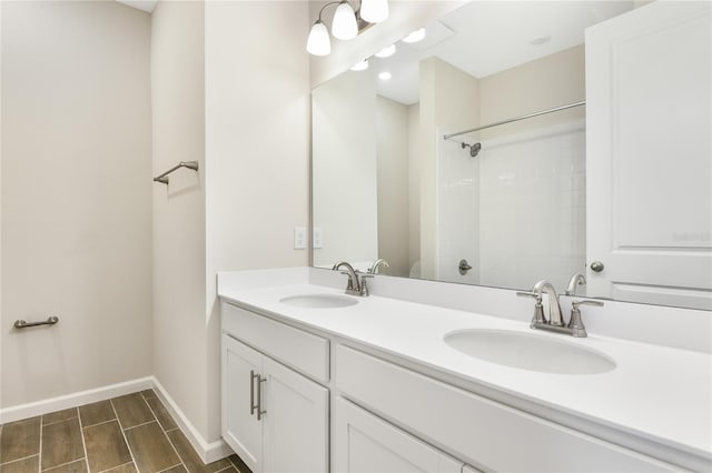 bathroom featuring a shower and vanity