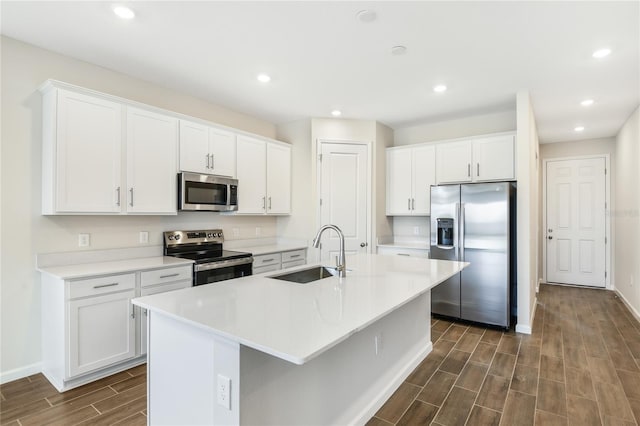 kitchen featuring white cabinetry, sink, an island with sink, and stainless steel appliances