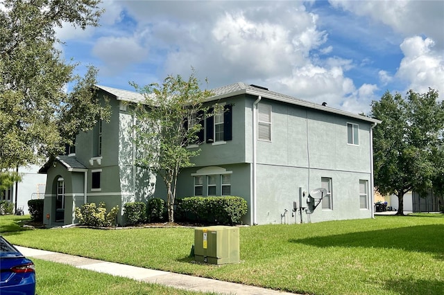 view of side of property with a yard