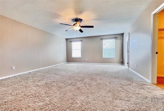 spare room featuring ceiling fan, carpet flooring, and a textured ceiling