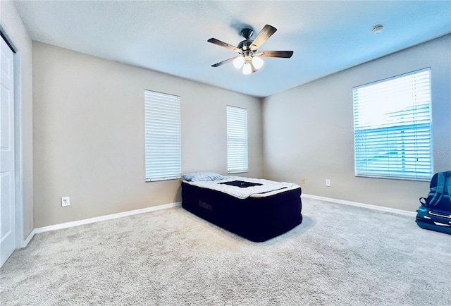 bedroom with ceiling fan and carpet floors