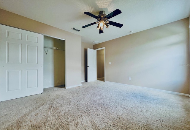 unfurnished bedroom with ceiling fan, a closet, and carpet