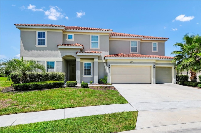 mediterranean / spanish home with driveway, a front lawn, and stucco siding