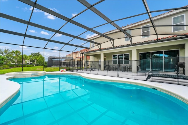 view of pool featuring a lanai, a patio area, and a pool with connected hot tub