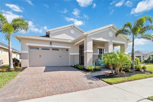 view of front of property featuring cooling unit and a garage