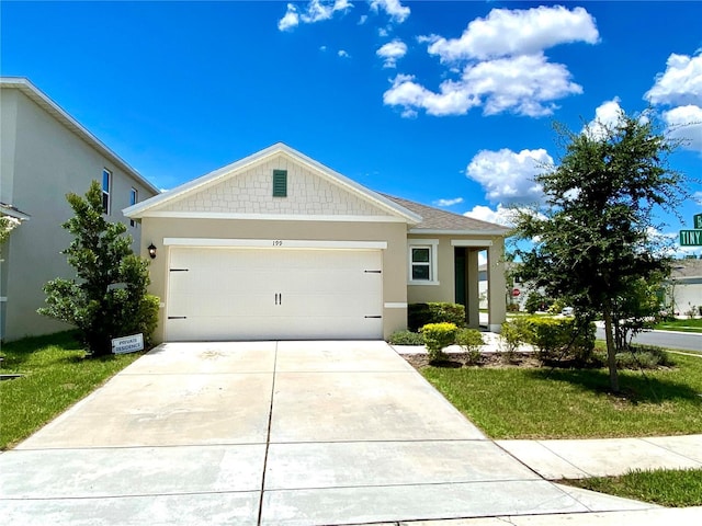 view of front of house with a garage and a front lawn