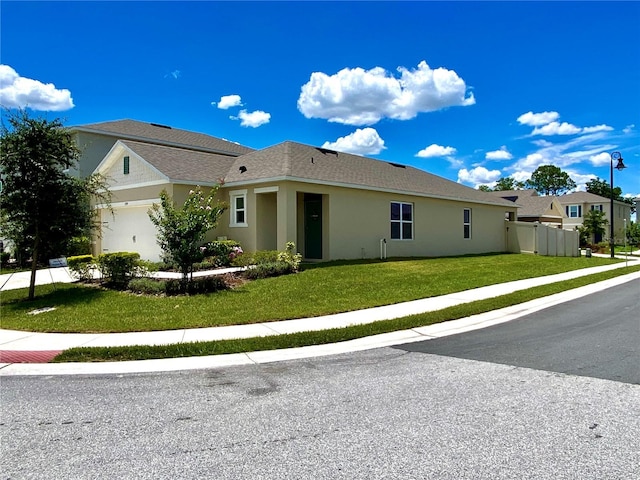 view of front of house featuring a front yard and a garage