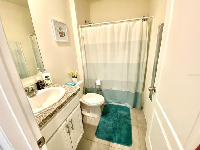 bathroom featuring toilet, a shower with curtain, vanity, and tile patterned floors