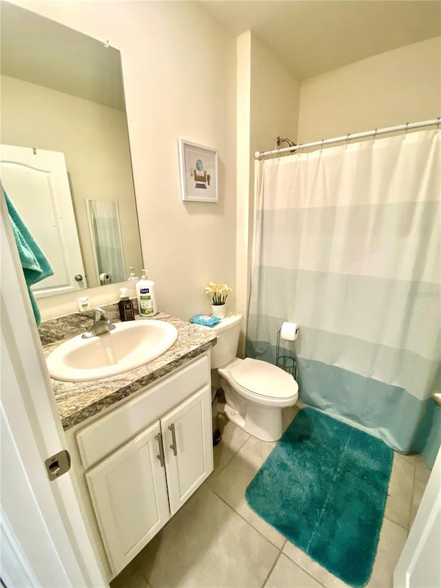 bathroom featuring tile patterned floors, vanity, and toilet