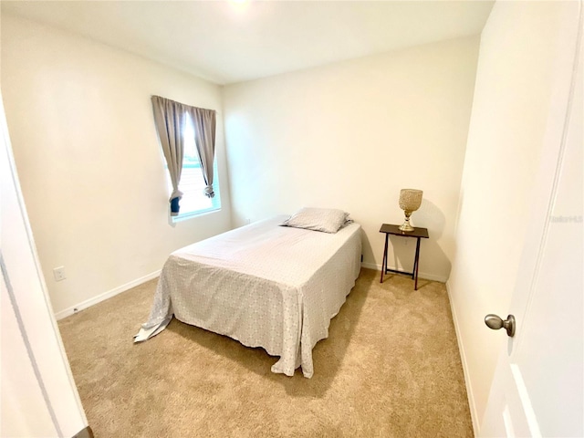 bedroom featuring light colored carpet