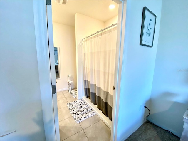 bathroom with tile patterned floors and curtained shower