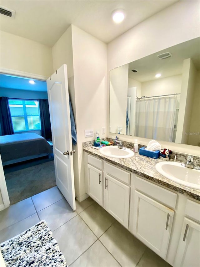 bathroom with tile patterned flooring and vanity