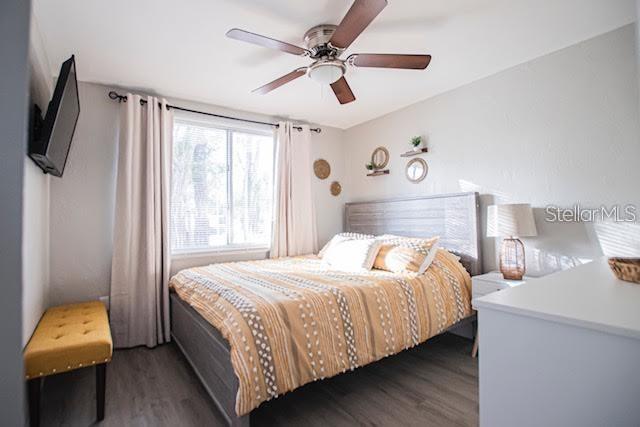 bedroom featuring ceiling fan and dark hardwood / wood-style floors