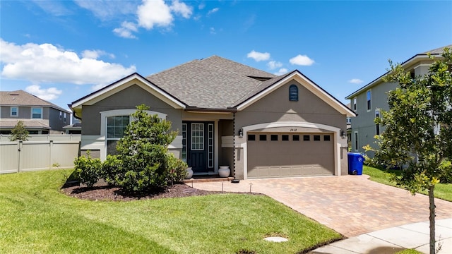 view of front of property with a garage and a front yard