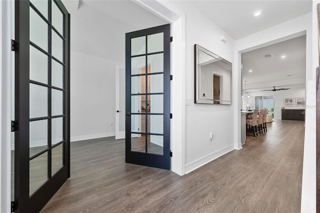 corridor with french doors and dark hardwood / wood-style flooring