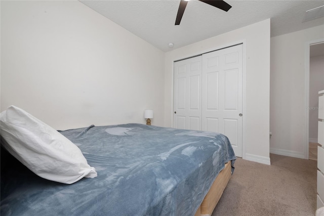 bedroom with a closet, carpet flooring, ceiling fan, and vaulted ceiling