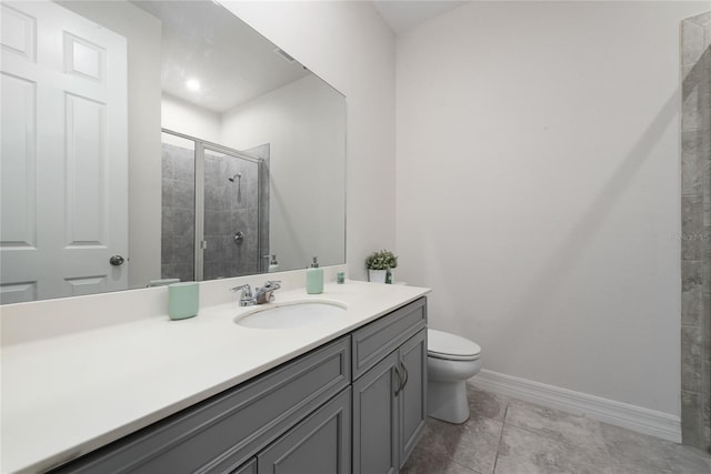 bathroom with a shower with shower door, vanity, tile patterned flooring, and toilet