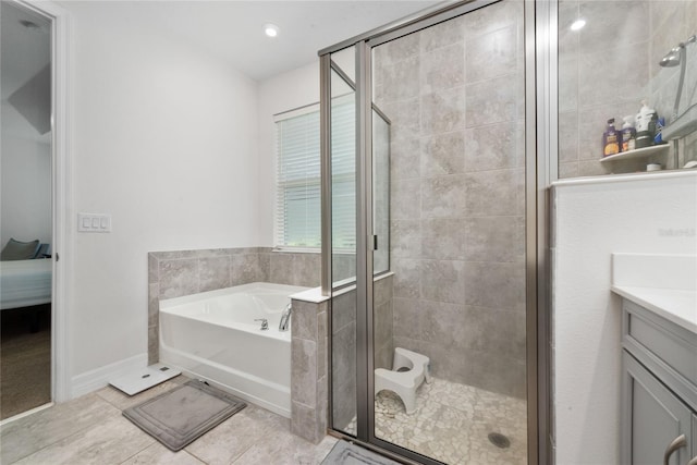 bathroom featuring tile patterned flooring, separate shower and tub, and vanity