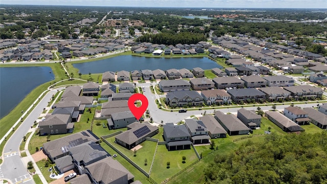 birds eye view of property with a water view