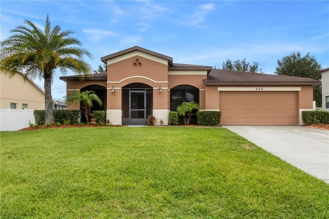 view of front of house featuring a front yard and a garage