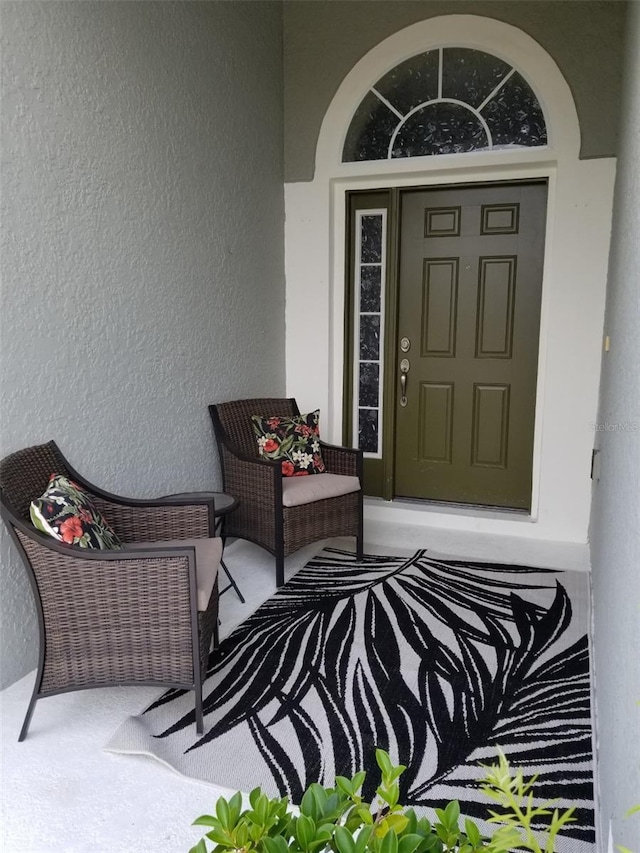 doorway to property with stucco siding