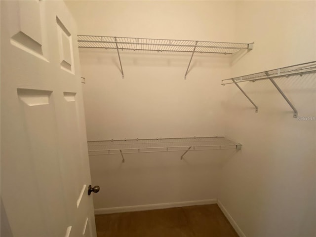 spacious closet with tile flooring