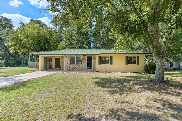 ranch-style house featuring a carport and a front yard