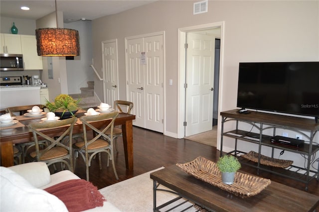 living room with dark hardwood / wood-style flooring