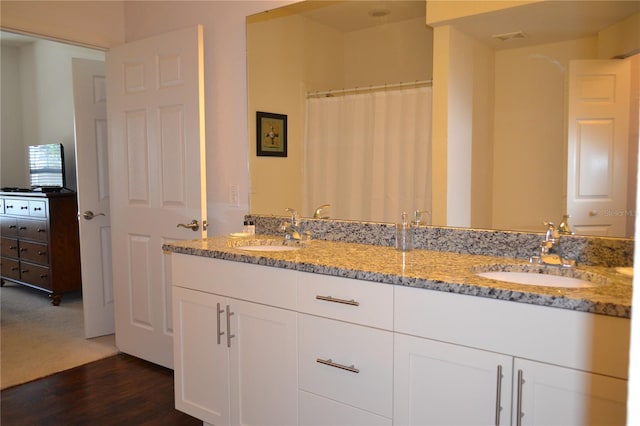 bathroom featuring vanity, curtained shower, and hardwood / wood-style floors