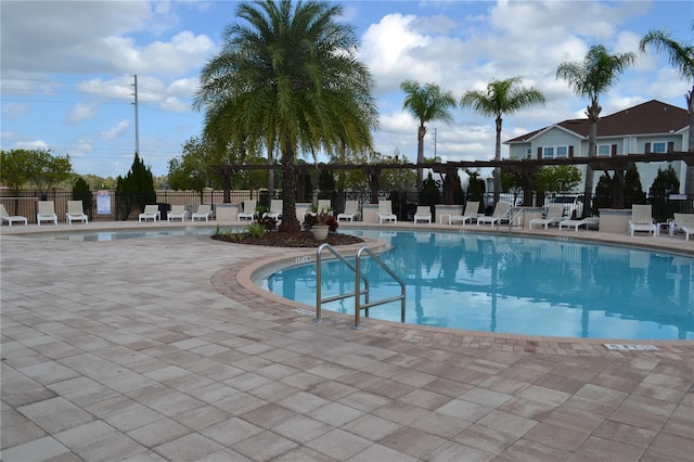 view of swimming pool featuring a patio and a pergola