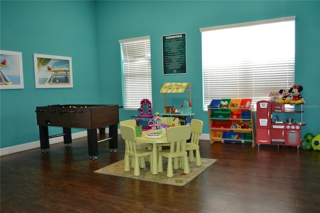 game room featuring dark wood-type flooring