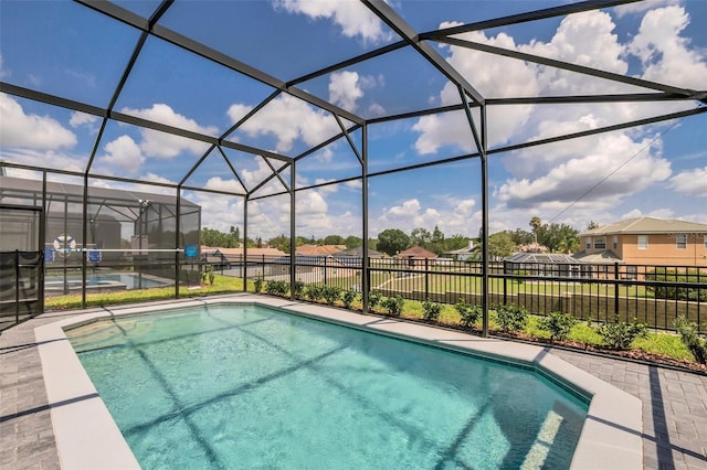 view of swimming pool with glass enclosure and a patio area