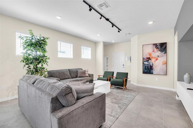 living room with a healthy amount of sunlight and rail lighting