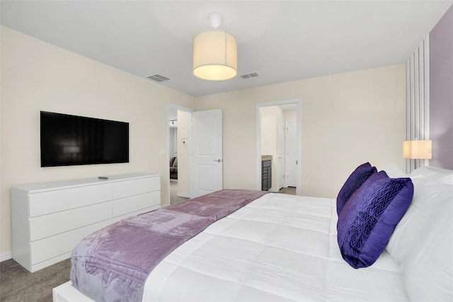 bedroom with light carpet and ensuite bath