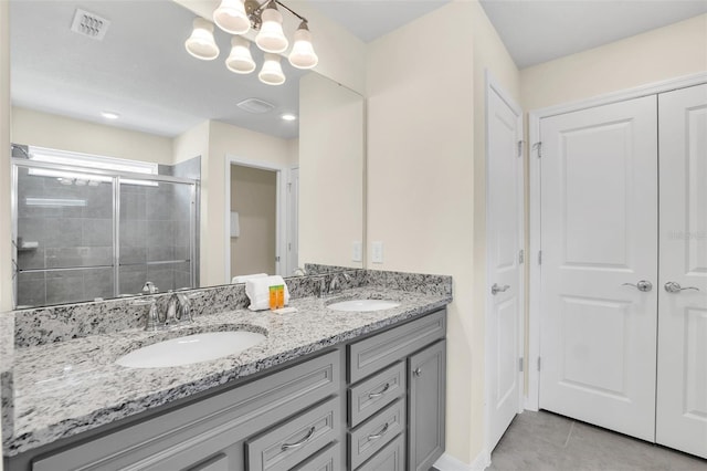 bathroom featuring vanity, tile patterned floors, a chandelier, and walk in shower