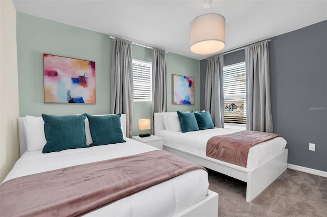 bedroom featuring multiple windows and light colored carpet