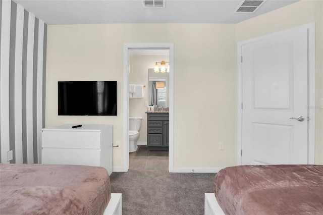 carpeted bedroom with ensuite bathroom