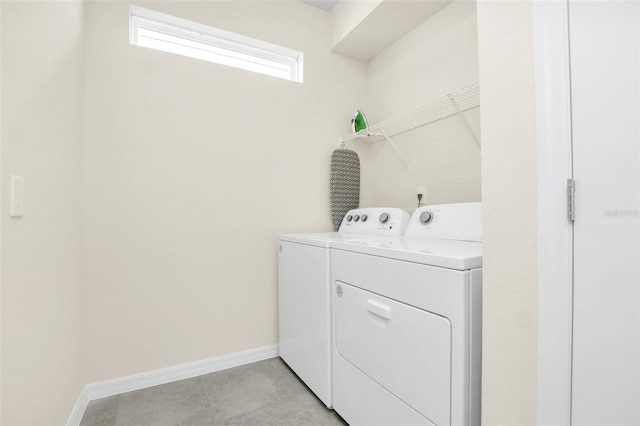 clothes washing area with washer and clothes dryer