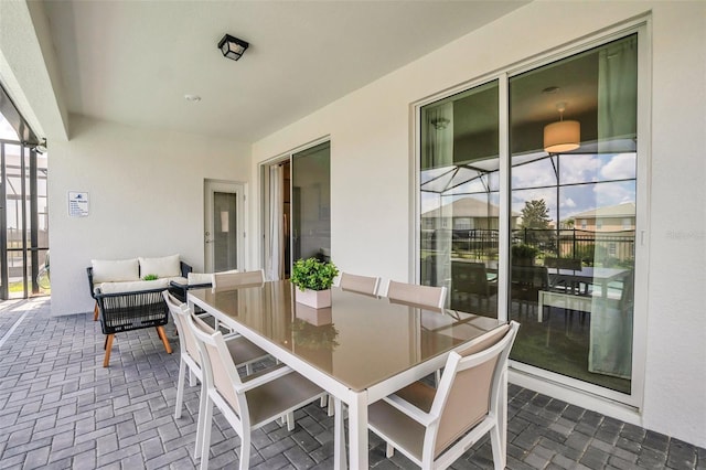 view of patio / terrace with outdoor lounge area and glass enclosure