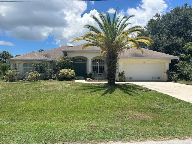 view of front of home featuring a garage and a front lawn