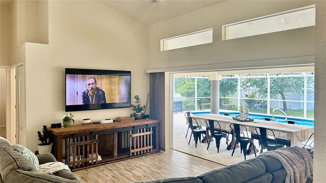 living room with a towering ceiling and hardwood / wood-style floors