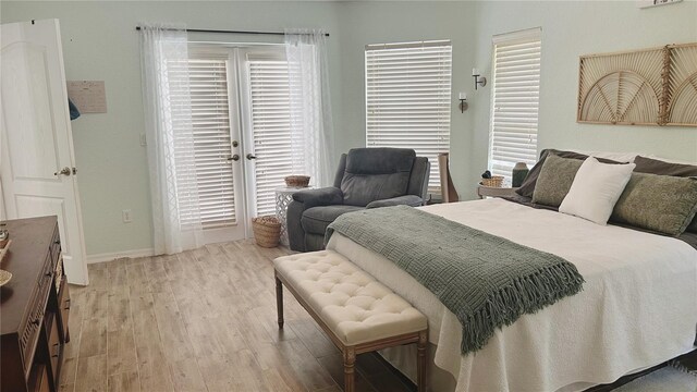 bedroom with wood-type flooring and multiple windows